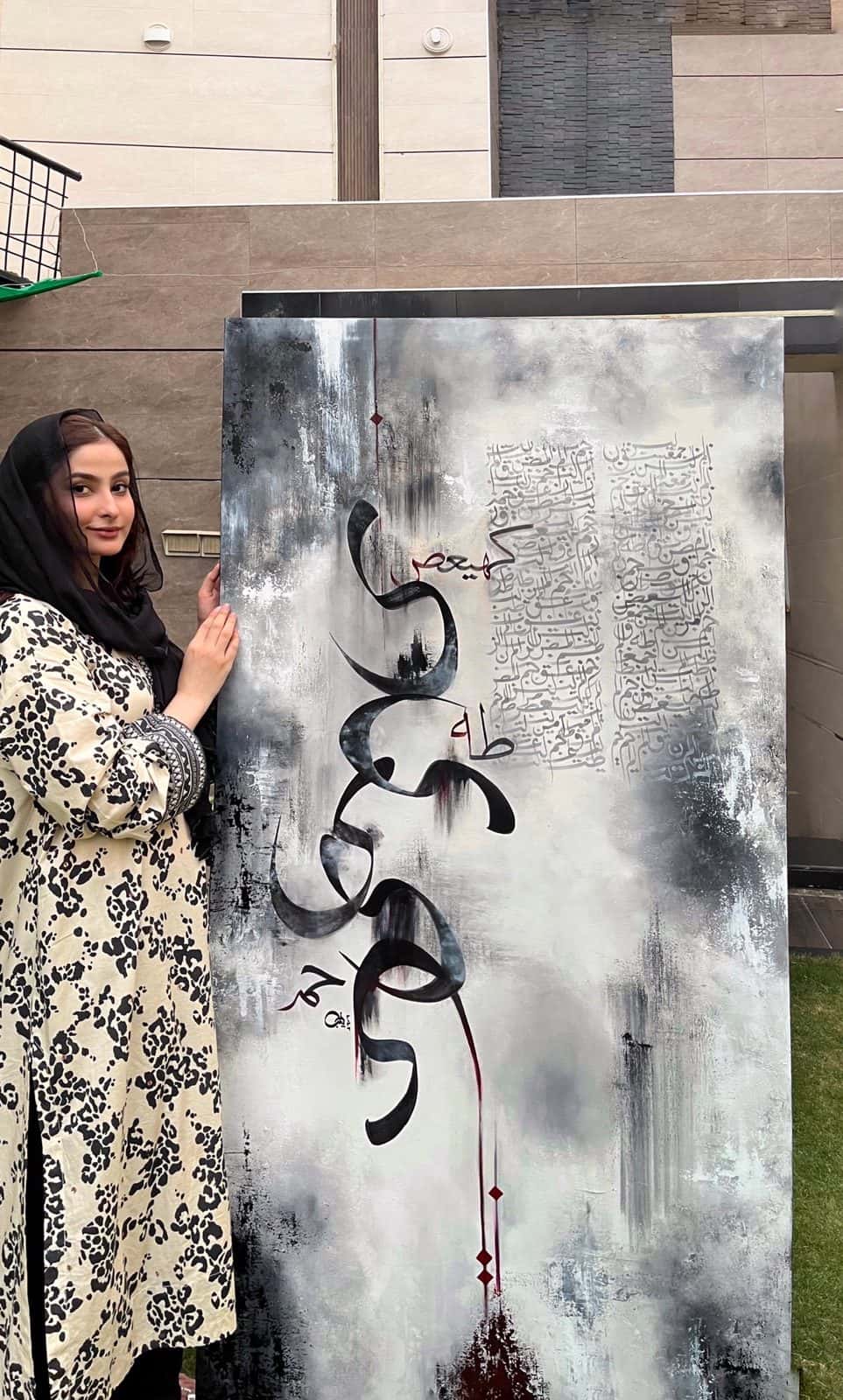 The artist with a calligraphy canvas at Zay__Alif